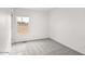Bright bedroom featuring a window overlooking the landscape and neutral carpet at 52002 W Sotol Rd, Maricopa, AZ 85139
