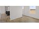 Open-concept living room with new vinyl flooring and sliding barn door at 52002 W Sotol Rd, Maricopa, AZ 85139