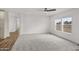 Spacious living room boasts neutral carpet, white walls, natural light from large window, and hardwood flooring at 52002 W Sotol Rd, Maricopa, AZ 85139