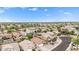 High-angle view of houses in a neighborhood, revealing backyard pools and manicured lawns under a bright blue sky at 528 E Kyle Ct, Gilbert, AZ 85296