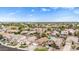 Wide aerial shot of a residential area featuring diverse homes, mature trees, and a clear sky in a peaceful community at 528 E Kyle Ct, Gilbert, AZ 85296