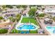 Aerial view of a landscaped backyard, featuring a pool, artificial grass, an outdoor kitchen, and a playground at 528 E Kyle Ct, Gilbert, AZ 85296
