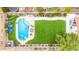 Aerial close-up of a backyard pool with lounge chairs, stylish decor, and a verdant artificial lawn at 528 E Kyle Ct, Gilbert, AZ 85296
