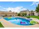 Sparkling backyard pool featuring playful floats and comfortable lounge seating on a sunny day at 528 E Kyle Ct, Gilbert, AZ 85296
