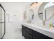 Bathroom with double sinks, modern lighting, and updated tile flooring at 528 E Kyle Ct, Gilbert, AZ 85296