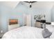 Cozy bedroom featuring a white bed with comfortable linens, modern decor, ceiling fan, and plenty of natural light at 528 E Kyle Ct, Gilbert, AZ 85296
