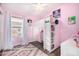 Adorable pink bedroom featuring a fun loft bed, built-in desk, charming decor, and ample natural light at 528 E Kyle Ct, Gilbert, AZ 85296