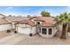 Charming home featuring a well-manicured front yard, a tiled roof, and an attached two-car garage at 528 E Kyle Ct, Gilbert, AZ 85296
