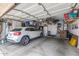 Spacious two-car garage featuring ample storage space, built-in shelving, and epoxy flooring at 528 E Kyle Ct, Gilbert, AZ 85296