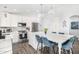 Modern kitchen with white cabinets, stainless steel appliances, and a large island with seating, ideal for gatherings at 528 E Kyle Ct, Gilbert, AZ 85296
