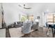 Cozy living room with comfortable seating, a ceiling fan, and large windows offering ample natural light at 528 E Kyle Ct, Gilbert, AZ 85296
