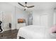 Bright bedroom featuring a ceiling fan, TV, and ensuite bathroom at 528 E Kyle Ct, Gilbert, AZ 85296