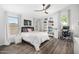 Bright bedroom with a ceiling fan, desk, and large bookshelf at 528 E Kyle Ct, Gilbert, AZ 85296