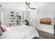 Bright bedroom with a ceiling fan, desk, ensuite bathroom, and TV at 528 E Kyle Ct, Gilbert, AZ 85296