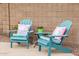 Charming patio seating with cozy Adirondack chairs, decorative pillows, and vibrant potted plants at 528 E Kyle Ct, Gilbert, AZ 85296