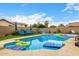Sparkling pool with lounge chairs, umbrellas, and fun floats offers a perfect backyard oasis for relaxation at 528 E Kyle Ct, Gilbert, AZ 85296