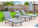 Relaxing poolside loungers and umbrella offer a perfect spot to unwind in a serene backyard setting at 528 E Kyle Ct, Gilbert, AZ 85296