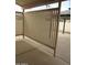 View of the backyard patio with wooden divider and patio cover at 6230 S Championship Dr, Chandler, AZ 85249