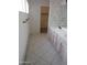 Bathroom featuring double sinks, cabinets, and neutral tiling at 6230 S Championship Dr, Chandler, AZ 85249