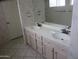 Bathroom featuring a double sink vanity with a large mirror, set against a wallpapered backdrop at 6230 S Championship Dr, Chandler, AZ 85249