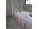 Bathroom featuring a double sink vanity with a large mirror, set against a wallpapered backdrop at 6230 S Championship Dr, Chandler, AZ 85249