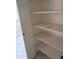 Linen closet with wood shelving and pink and white polka dot coverings at 6230 S Championship Dr, Chandler, AZ 85249