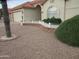 Manicured front yard featuring desert landscaping, a small white fence, and mature trees at 6230 S Championship Dr, Chandler, AZ 85249