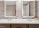 Modern bathroom with double sinks, large illuminated mirrors, and elegant fixtures for a clean and refined aesthetic at 6311 E Phoenician Blvd # 19, Scottsdale, AZ 85251