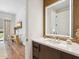 Modern bathroom featuring a vanity with marble countertop, stylish mirror, and open doorway to a cozy, decorated living space at 6311 E Phoenician Blvd # 19, Scottsdale, AZ 85251