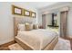 Inviting bedroom featuring a plush bed, tasteful artwork, and a window with elegant curtains, creating a cozy retreat at 6311 E Phoenician Blvd # 19, Scottsdale, AZ 85251