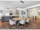 Dining area featuring a marble table, crystal chandeliers, and open access to the kitchen at 6311 E Phoenician Blvd # 19, Scottsdale, AZ 85251