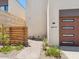 Close up of modern home entryway with desert landscaping and wood architectural detail at 6311 E Phoenician Blvd # 19, Scottsdale, AZ 85251