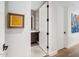 Bright hallway leading to a stylish bathroom, accentuated with modern art and dark hardware for a sophisticated touch at 6311 E Phoenician Blvd # 19, Scottsdale, AZ 85251