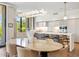 Bright kitchen and dining area with modern island, stainless appliances and wood flooring at 6311 E Phoenician Blvd # 19, Scottsdale, AZ 85251