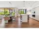Open-concept kitchen with dining area, hardwood floors, and stylish pendant lighting at 6311 E Phoenician Blvd # 19, Scottsdale, AZ 85251
