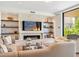 Inviting living room with a fireplace, shelving, stylish seating, and a view of the outdoors at 6311 E Phoenician Blvd # 19, Scottsdale, AZ 85251