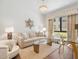Cozy living room with a neutral palette, stylish seating, glass coffee table, and ample natural light from the window at 6311 E Phoenician Blvd # 19, Scottsdale, AZ 85251
