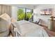 Bright main bedroom features art, furniture, and a view outside the glass doors at 6311 E Phoenician Blvd # 19, Scottsdale, AZ 85251
