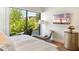 A view of the main bedroom shows a private balcony with green trees outside at 6311 E Phoenician Blvd # 19, Scottsdale, AZ 85251