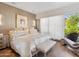 Bright main bedroom features a balcony, lounge chair, and elegant decor at 6311 E Phoenician Blvd # 19, Scottsdale, AZ 85251