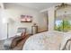 Bright main bedroom features art, elegant furniture, and a large glass window at 6311 E Phoenician Blvd # 19, Scottsdale, AZ 85251