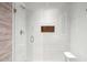 Modern shower with sleek white tiling, a glass door, and a built-in niche, perfect for a minimalist and clean bathroom at 6311 E Phoenician Blvd # 19, Scottsdale, AZ 85251