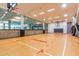 Indoor basketball court with finished wood floor and natural light via window wall at 7167 E Rancho Vista Dr # 4011, Scottsdale, AZ 85251