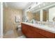 Bright bathroom featuring a double vanity, large mirror, tile walls, and modern lighting fixtures at 7167 E Rancho Vista Dr # 4011, Scottsdale, AZ 85251