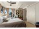 Bedroom with plush bedding, large windows, and a ceiling fan, creating a relaxing atmosphere at 7167 E Rancho Vista Dr # 4011, Scottsdale, AZ 85251