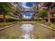 Stunning courtyard view with water feature, putting green, lounge chairs, lush landscaping, and residential architecture at 7167 E Rancho Vista Dr # 4011, Scottsdale, AZ 85251