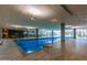 Bright indoor pool area with lap lanes, fitness center view, and tile surround at 7167 E Rancho Vista Dr # 4011, Scottsdale, AZ 85251