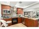 Kitchen featuring modern appliances, wooden cabinets, tile floors, and island with bar stool seating at 7167 E Rancho Vista Dr # 4011, Scottsdale, AZ 85251