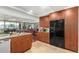 Modern kitchen with stainless steel appliances and wooden cabinets and large breakfast bar at 7167 E Rancho Vista Dr # 4011, Scottsdale, AZ 85251