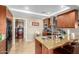 Kitchen features tile floors, stainless steel appliances, island with seating, and laundry area at 7167 E Rancho Vista Dr # 4011, Scottsdale, AZ 85251